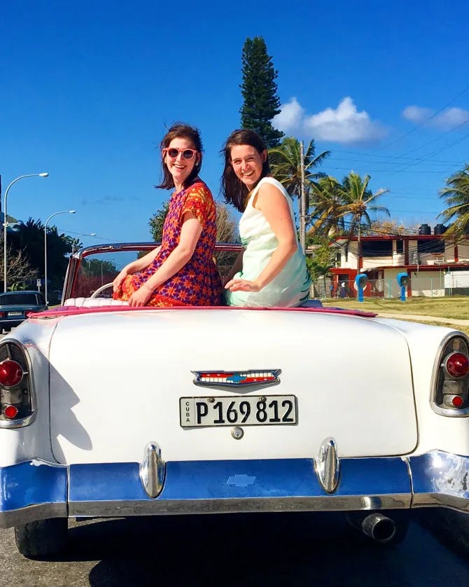 Females sitting on a car's top