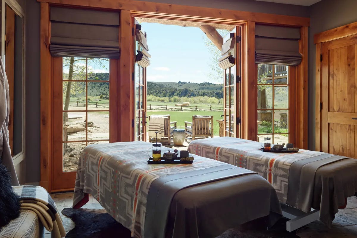 two spa treatment beds in a log cabin