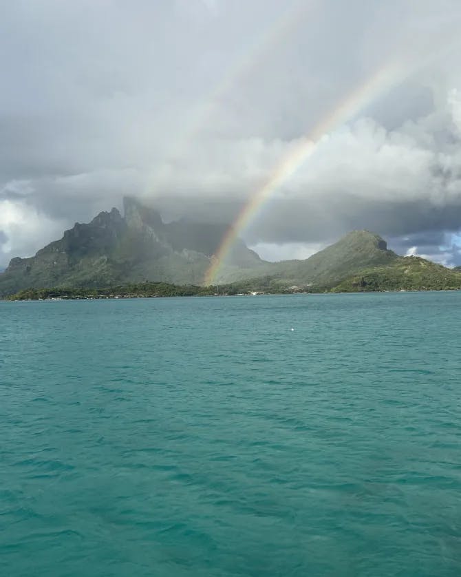 View of the sea, sea stacks, rainbow, and sky