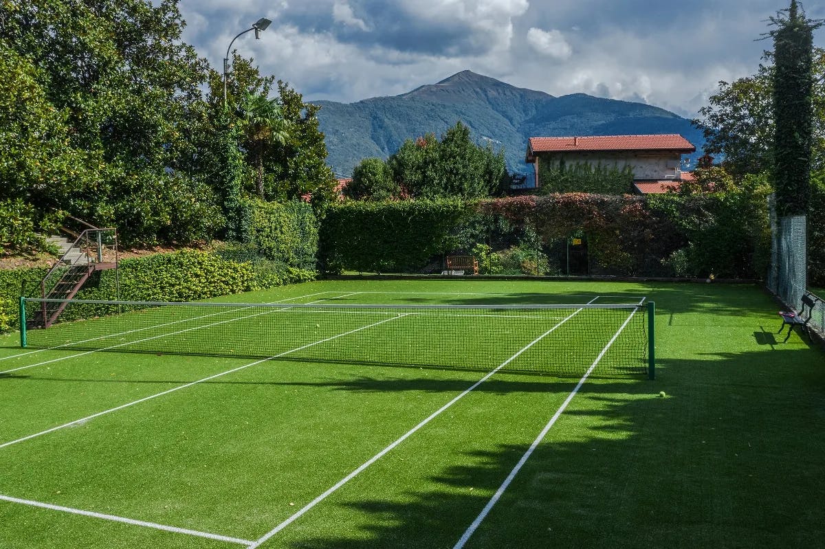 a luxe green tennis court in the mountains