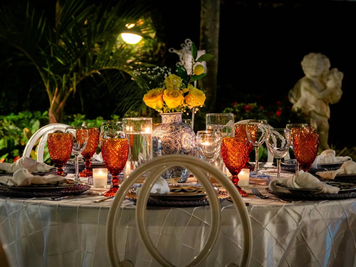 A table set for a romantic dinner with candles and flowers.