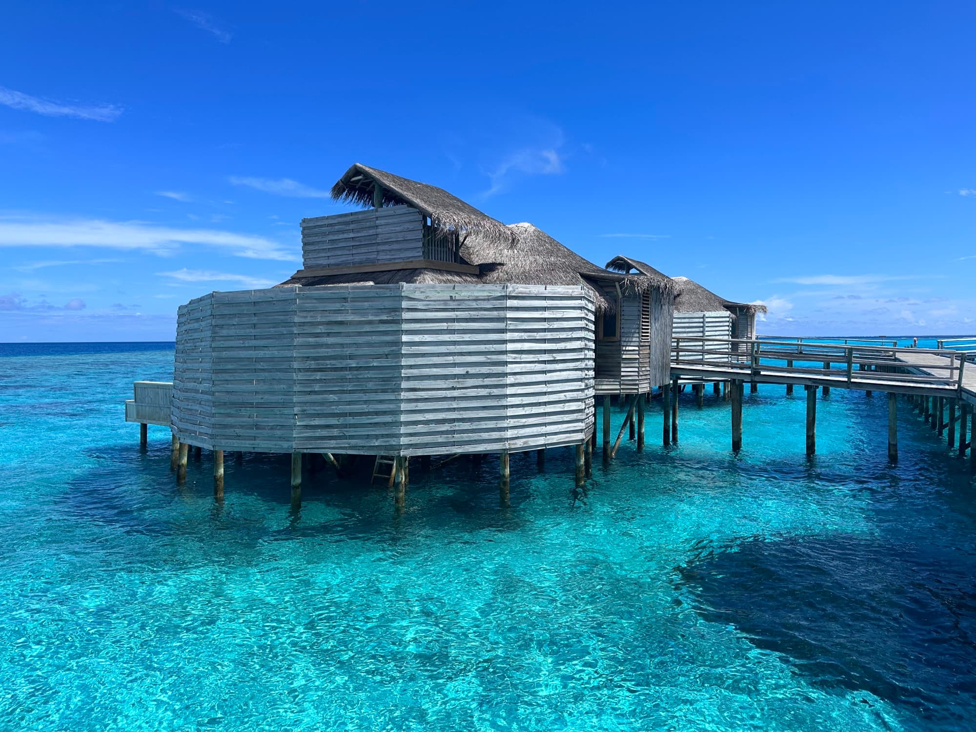 A gorgeous bungalow above the crystal clear turquoise water in the Maldives. 