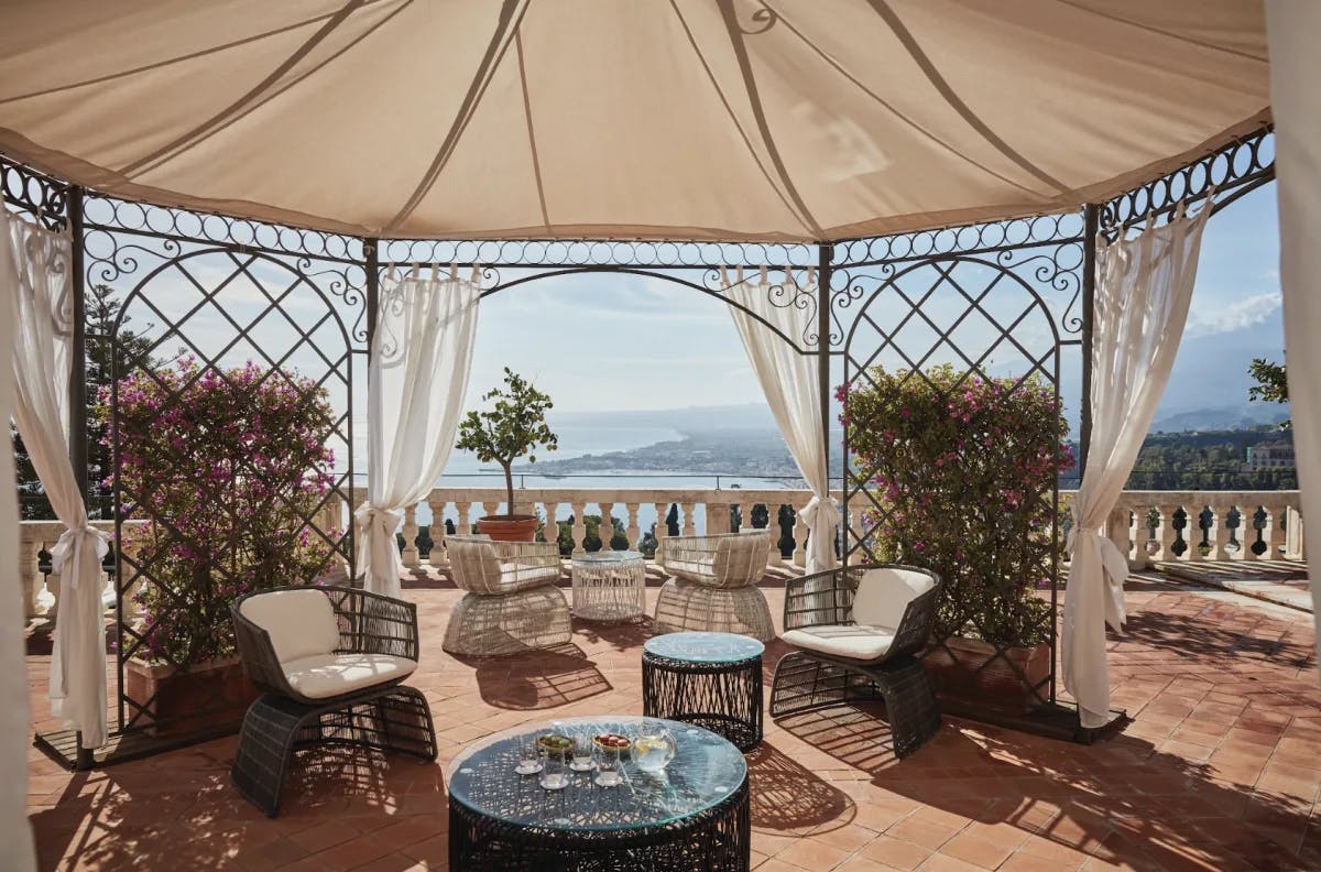 an outdoor covered rotunda overlooking the sea