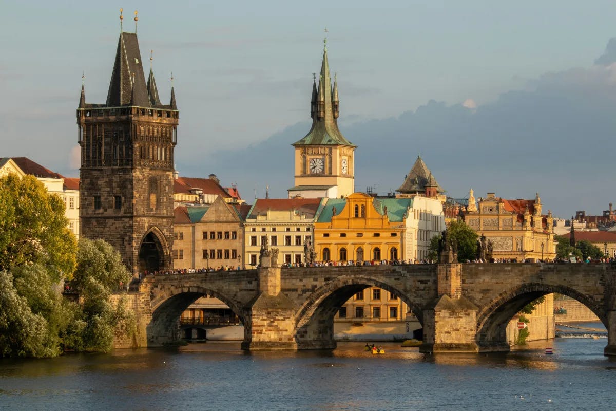 Beautiful view of the Charles Bridge and surrounding buildings by the river in Prague