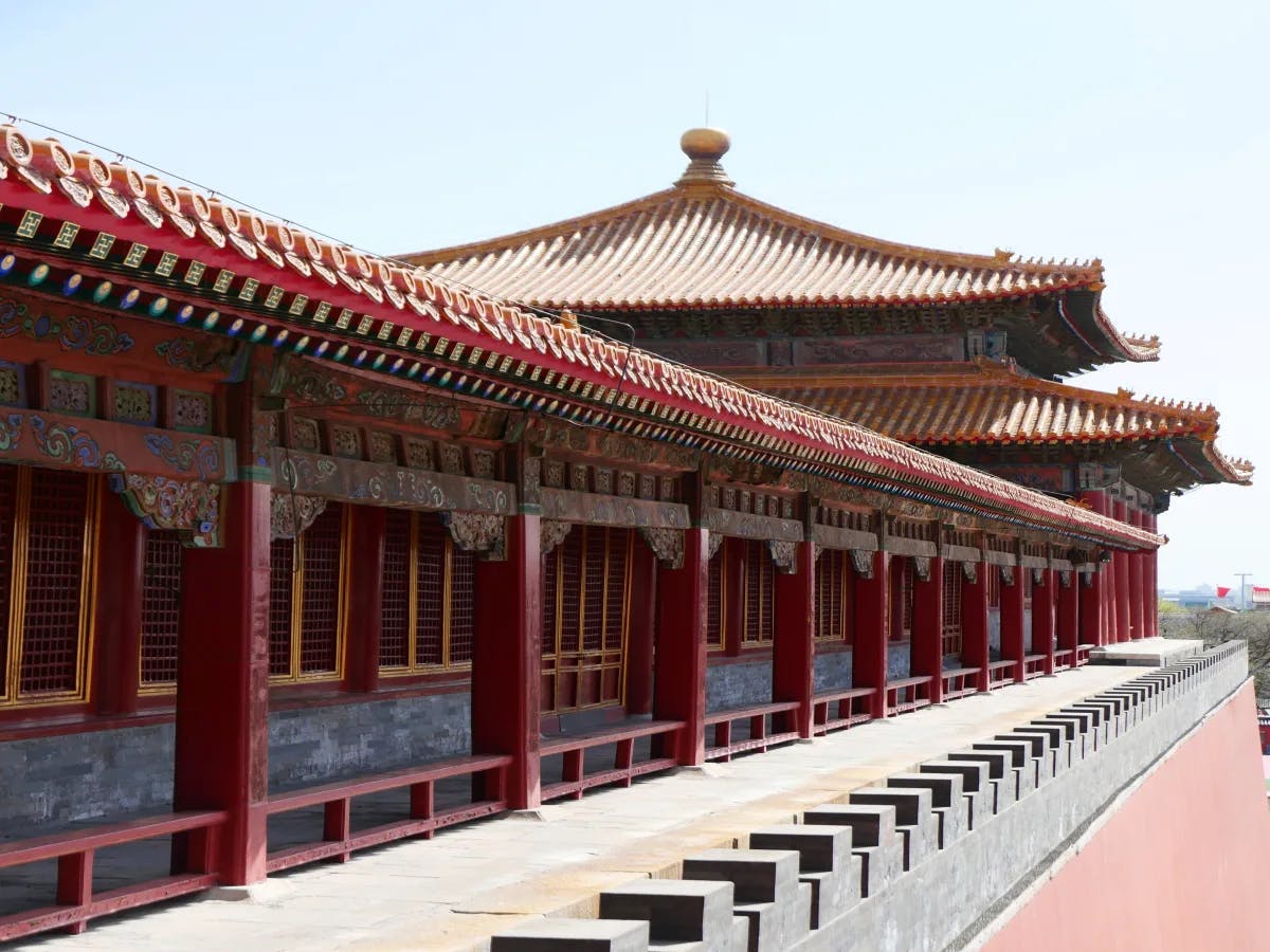 A picture of a red-colored Chinese-style building during the daytime.