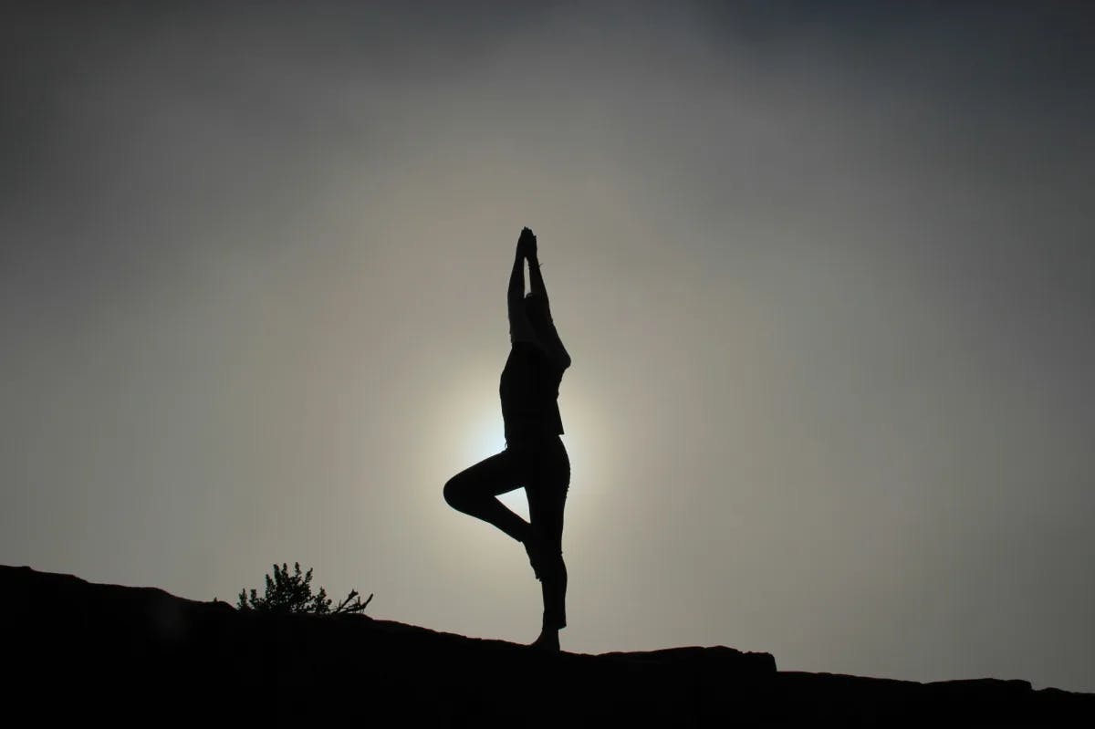 Silhouette of a person doing yoga.