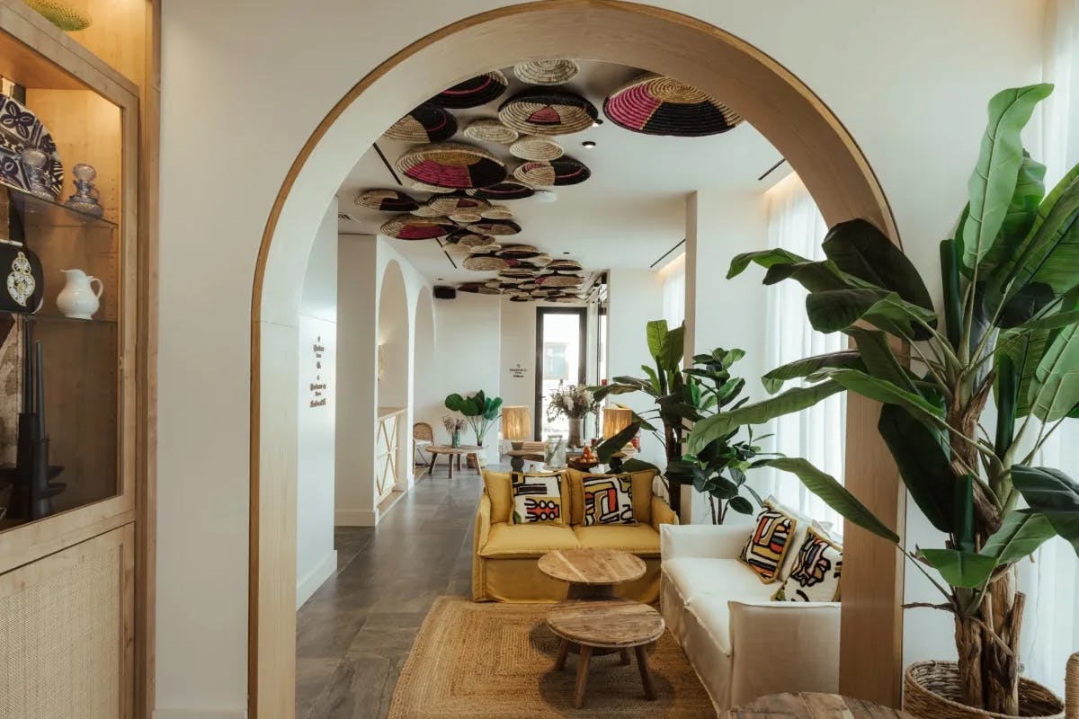 hallway with arched doorways and decorative baskets on the ceiling