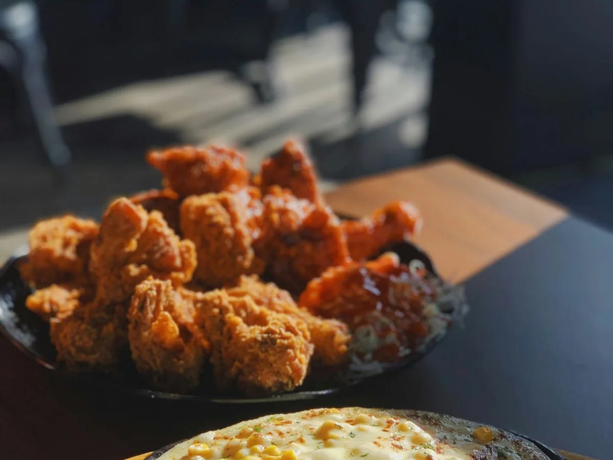 Fried chicken on a black plate. 