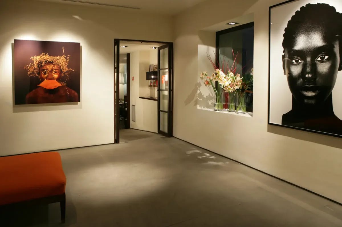 Various works of art and a floral arrangement fill a gallery 