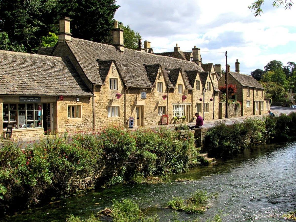 A row of stone houses next to a river during the daytime