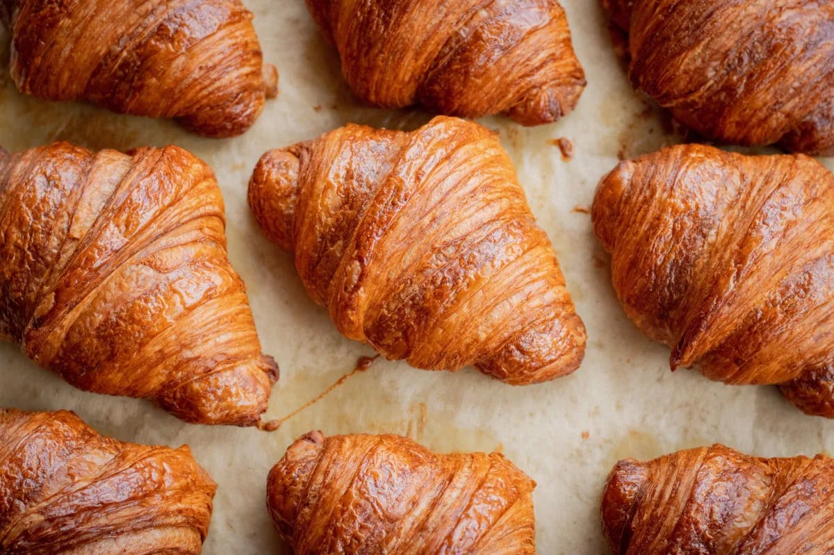 Baked croissants on a baking sheet. 