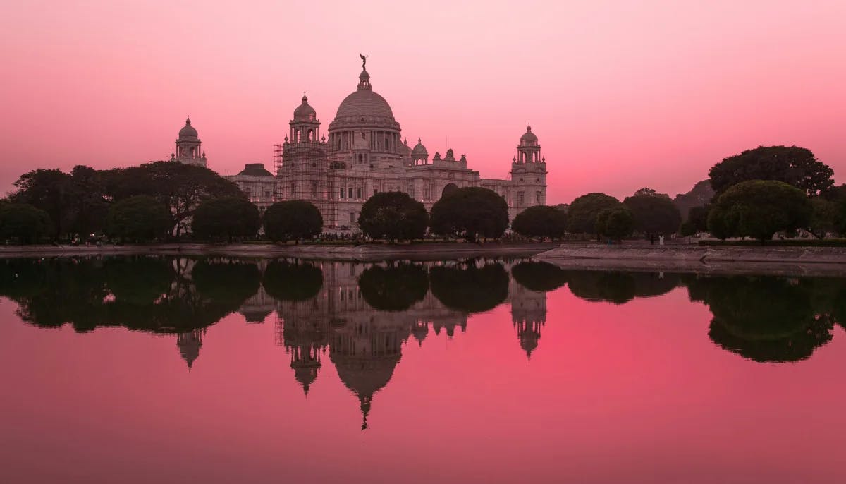 An aerial view of a beautiful sunset in India with a classic building and water way