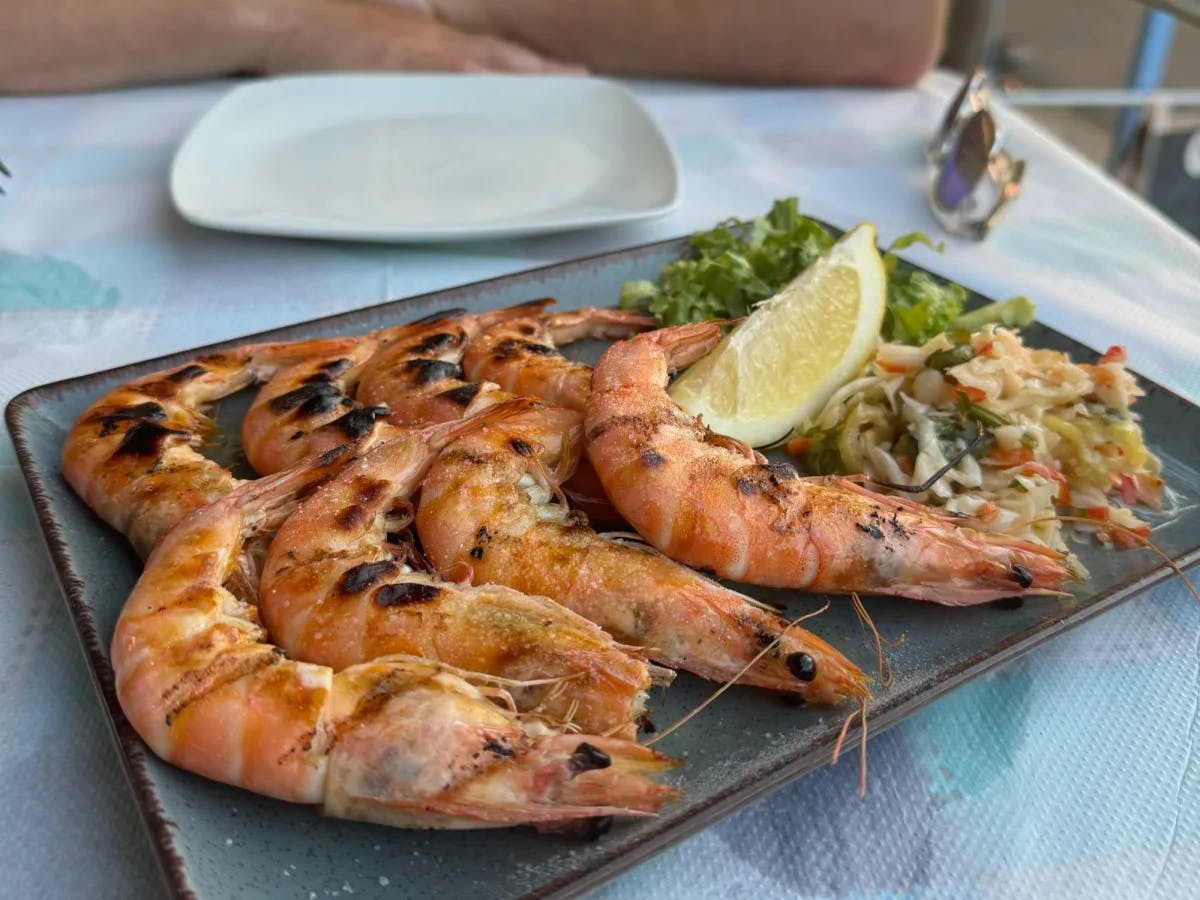 Cooked shrimp on a plate on an outdoor table