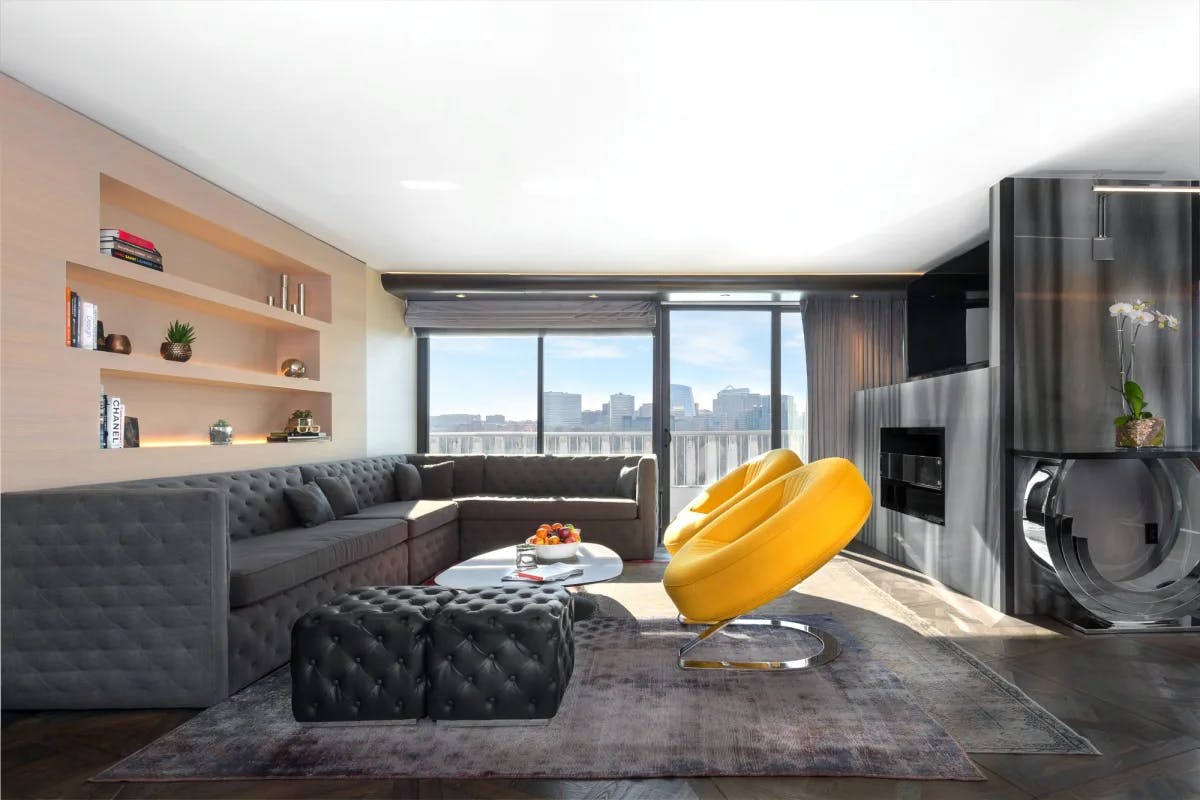 a modern living room with yellow circular chairs and a gray L-shaped couch