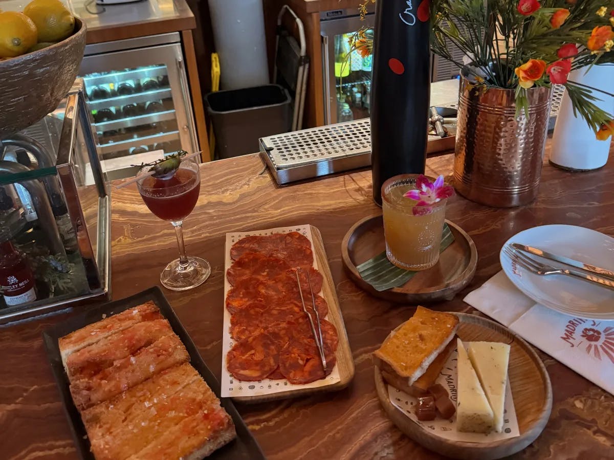 A restaurant scene with an array of food and drinks served on the table.