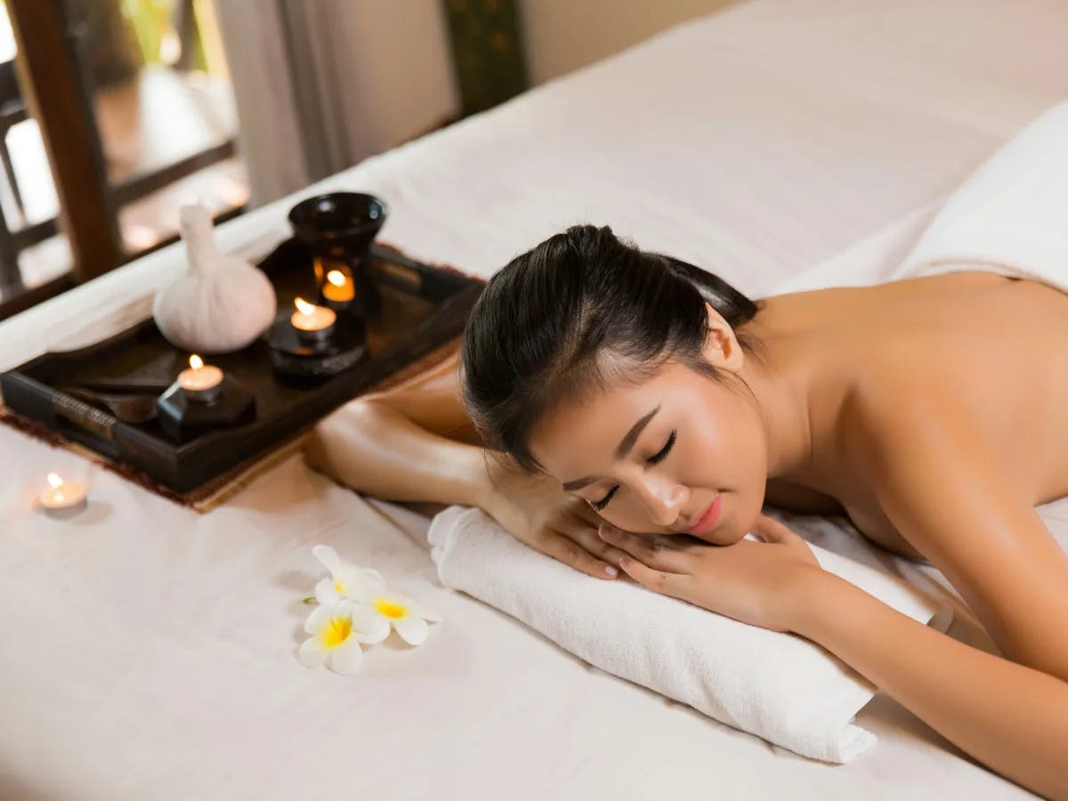 A person in a spa, getting a massage in a peaceful environment.