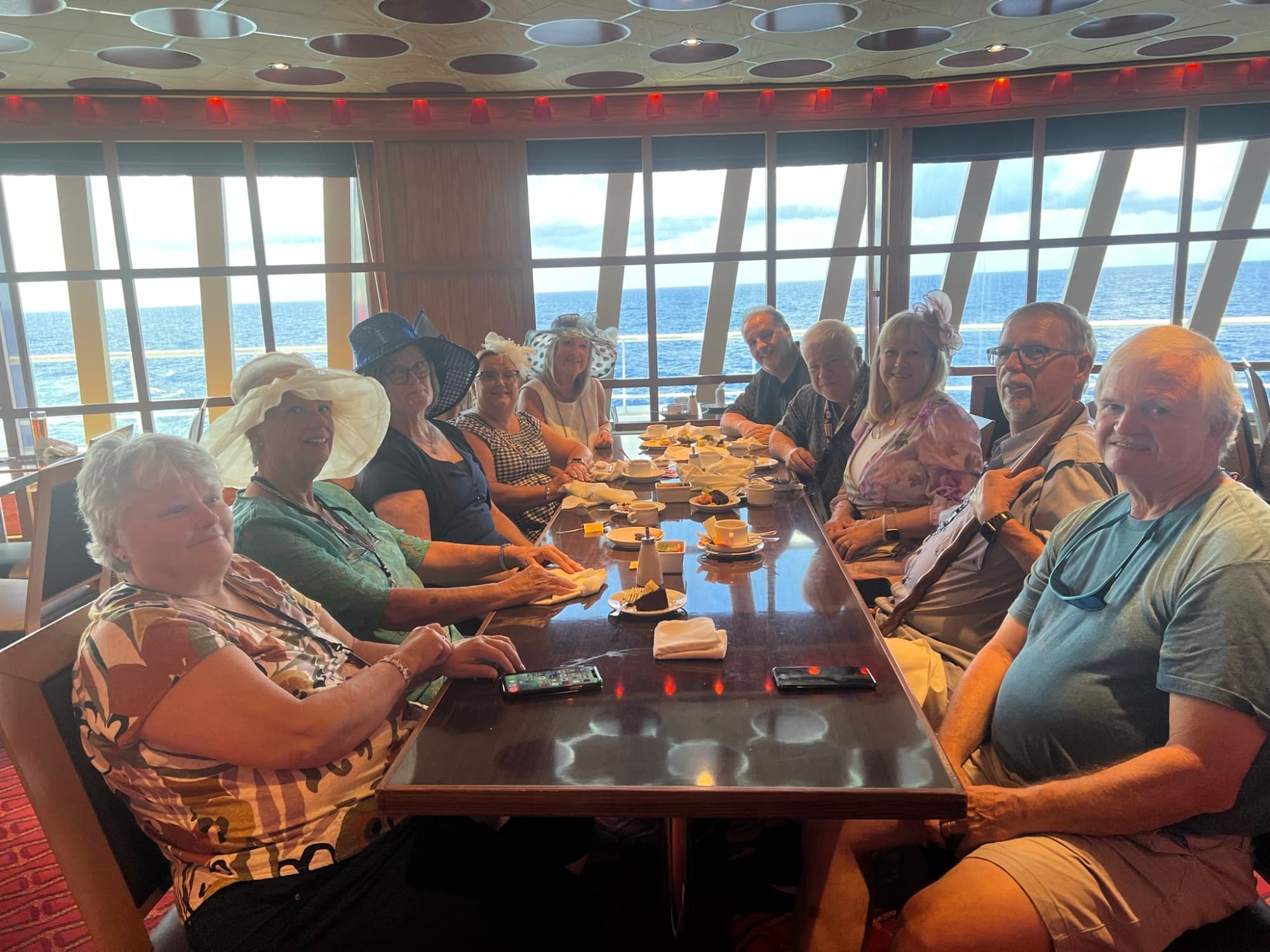 A group of people sitting at a table smiling for a photograph