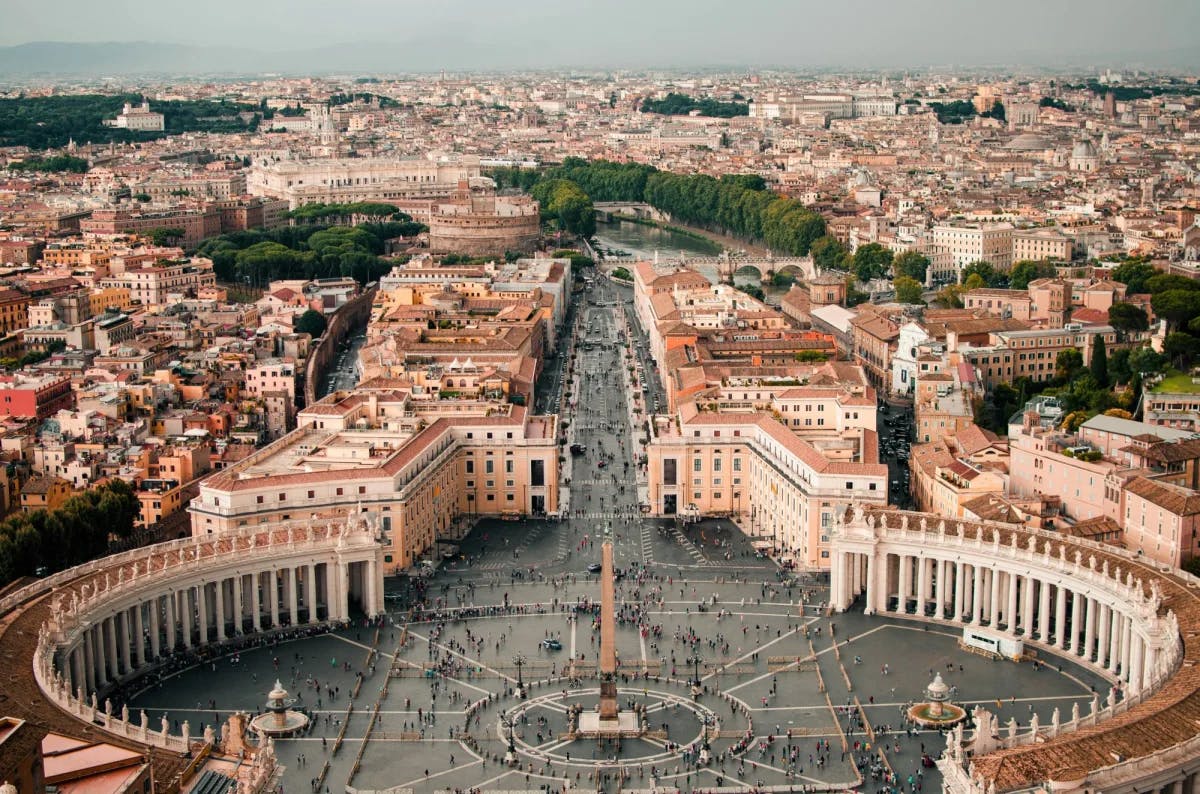 AAerial picture of Rome city with a large square with central monument.