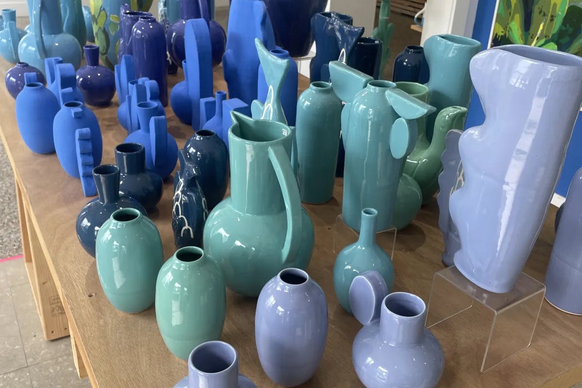 Blue, green and purple ceramic selection on a table at Key West Pottery.