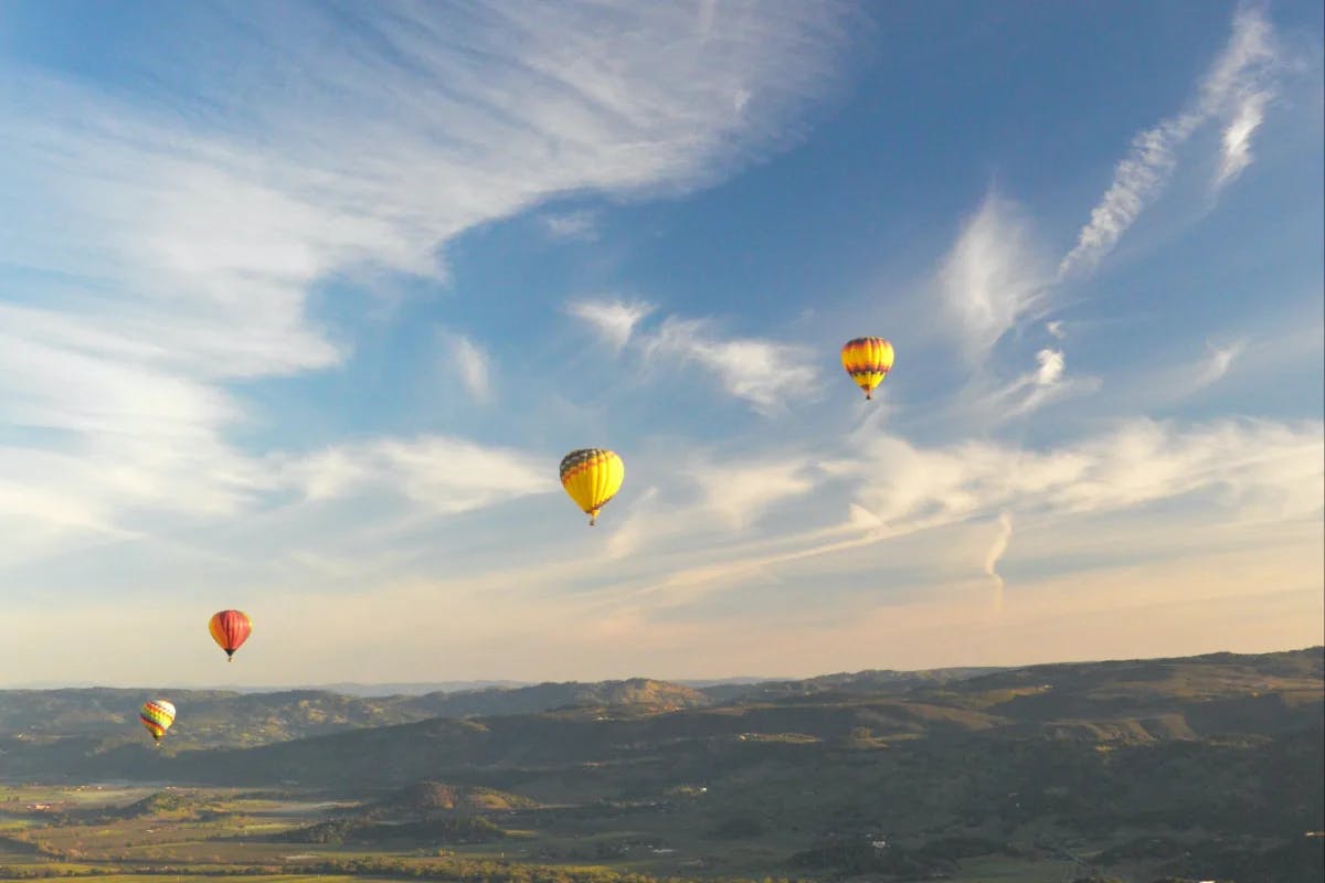 Yellow and red hot air balloons in the sky during daytime