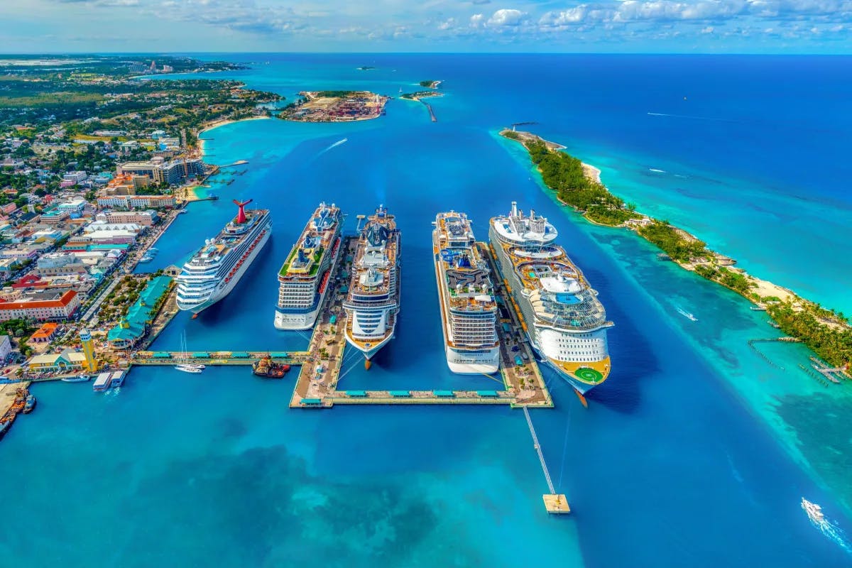 Aerial view of 5 cruise ships docked at a port