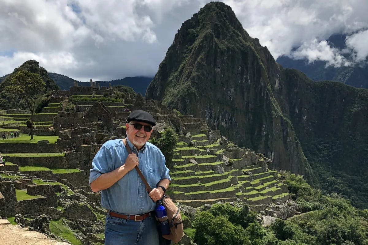 Posing behind the landscape of Machu Picchu.