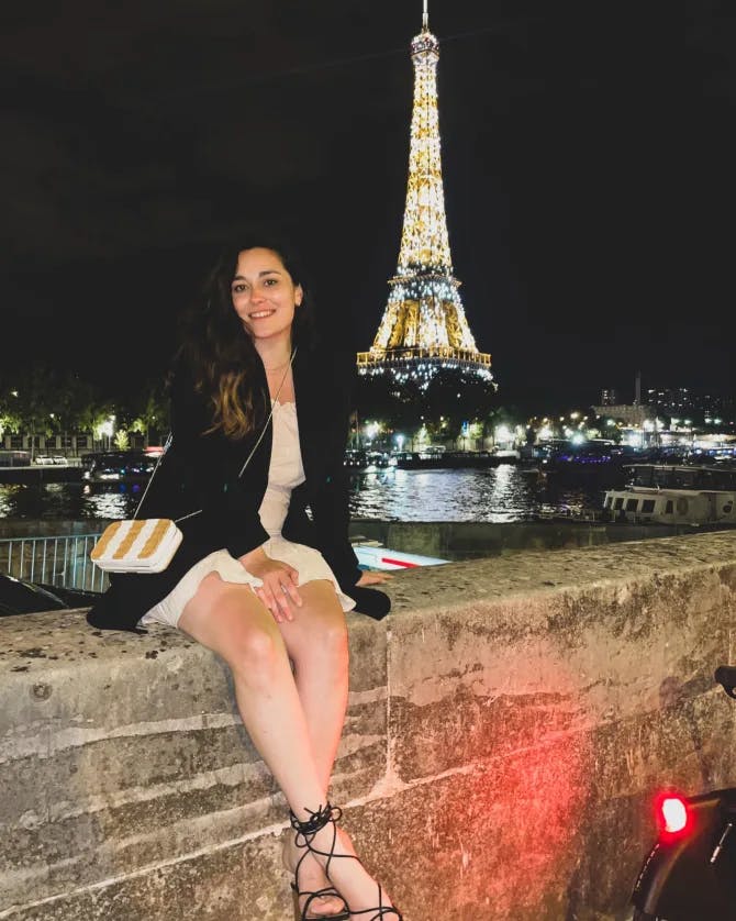 Travel advisor Adriana Vivas posing by the Eiffel Tower