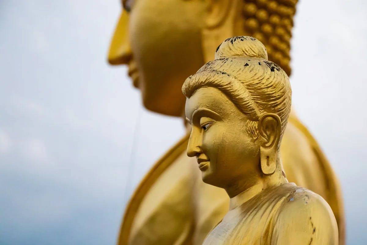 Two large gold statues of Buddha