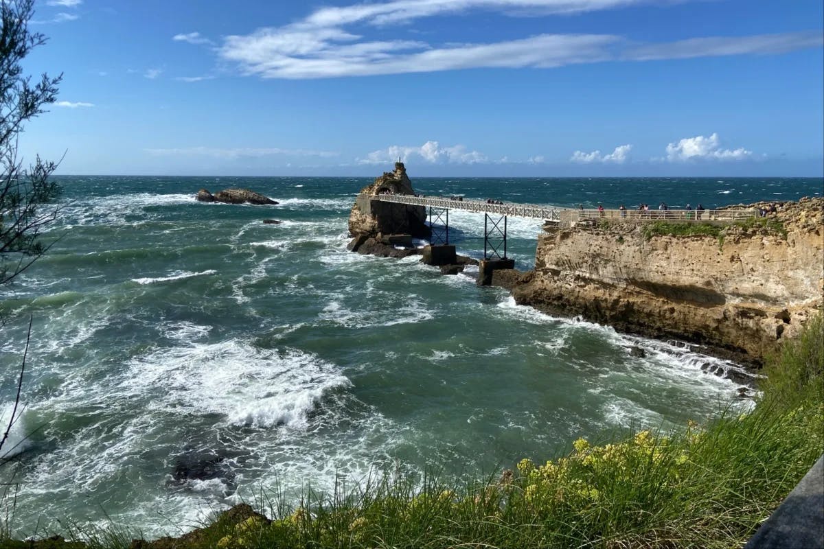 The Rock of the Virgin Mary, a large rock formation in the ocean connected to the coast by a bridge.