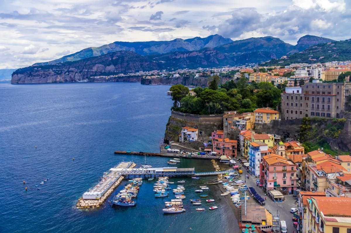 View of harbor and pictureque coastline with colorful buildings on the Amalfi Coast.