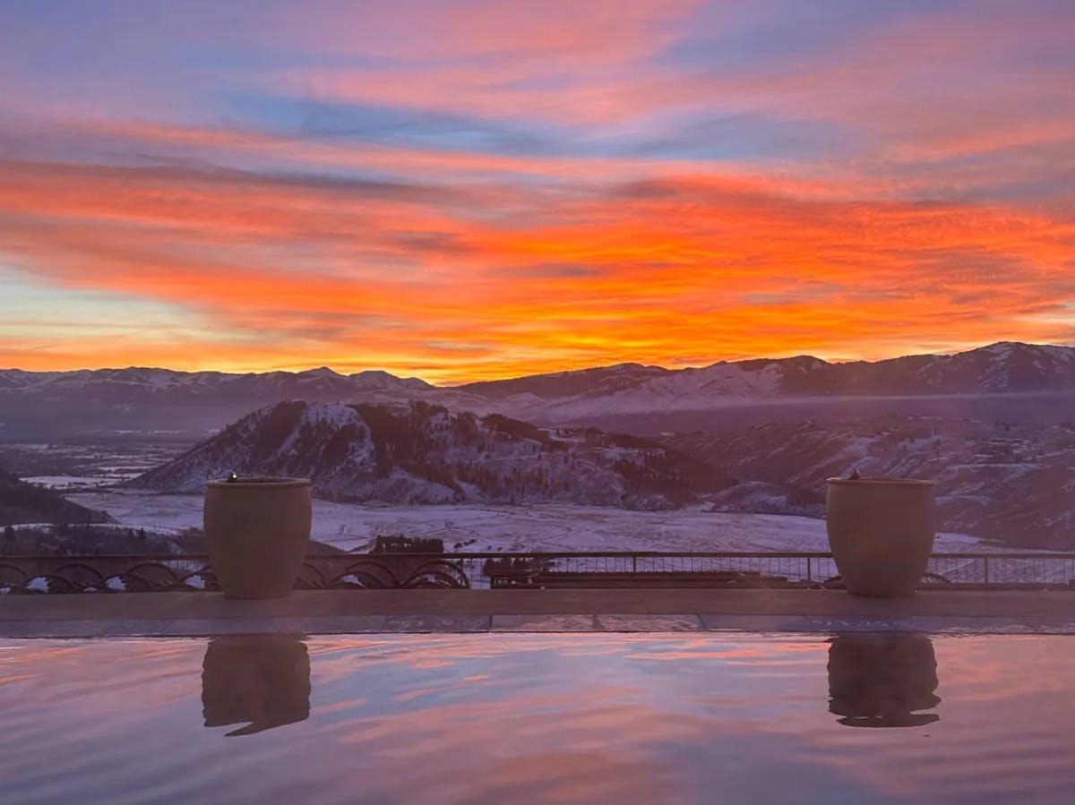 A fire-orange sunset over the snowy mountains of Jackson Hole. 