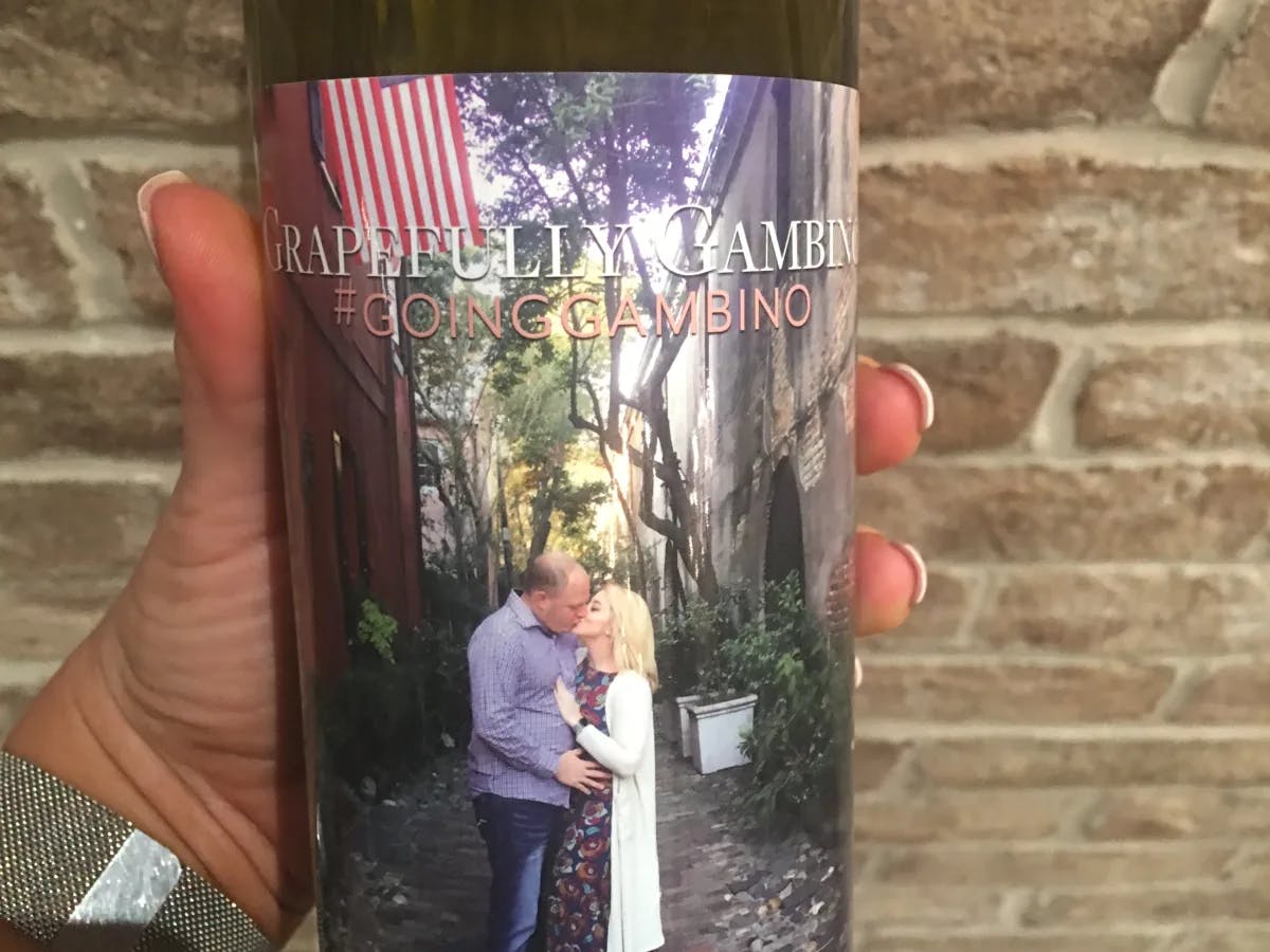 A custom wine label with a photo of a couple kissing in the street