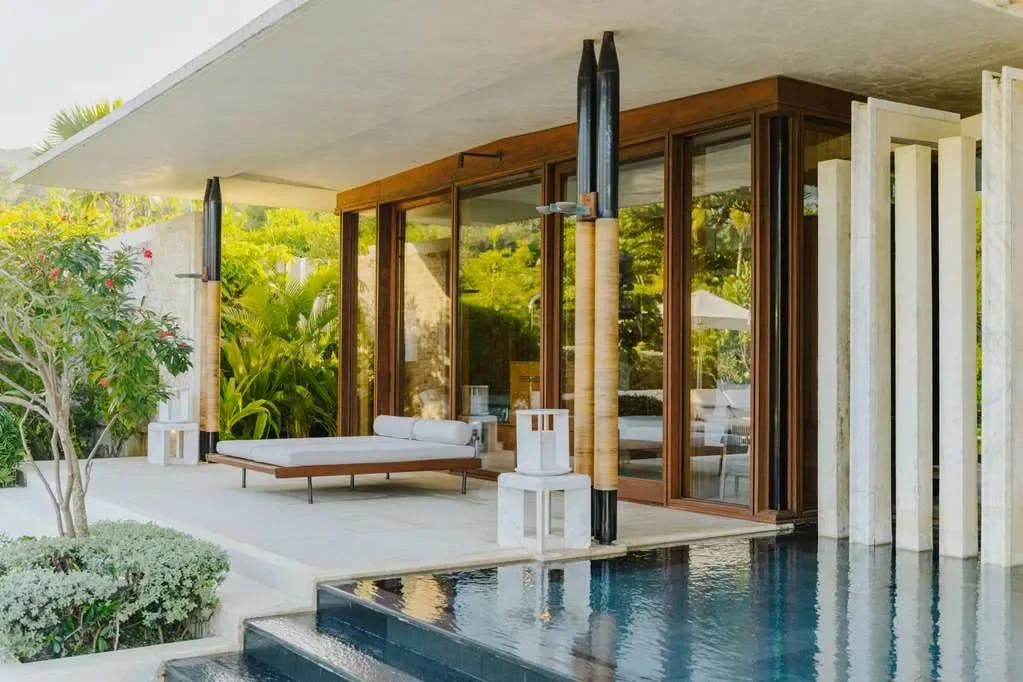 a sleek deck with gray loungers near a tiered infinity pool