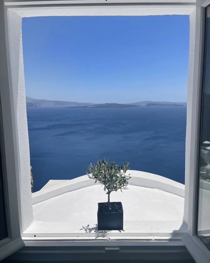 View of the ocean and clear skies as seen from a window