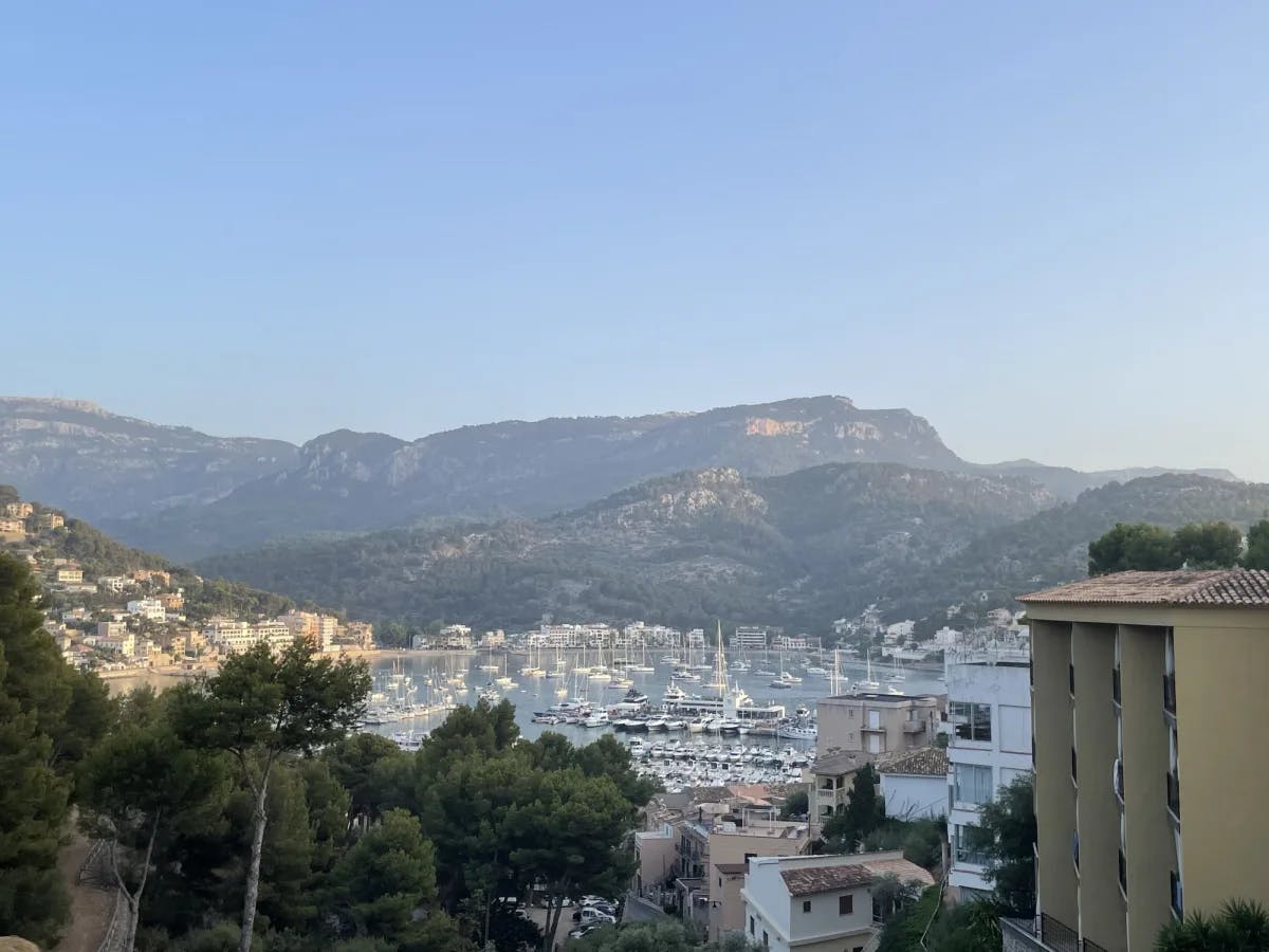 A view of the Mallorcan town, sea, marina and mountains on a sunny day. 