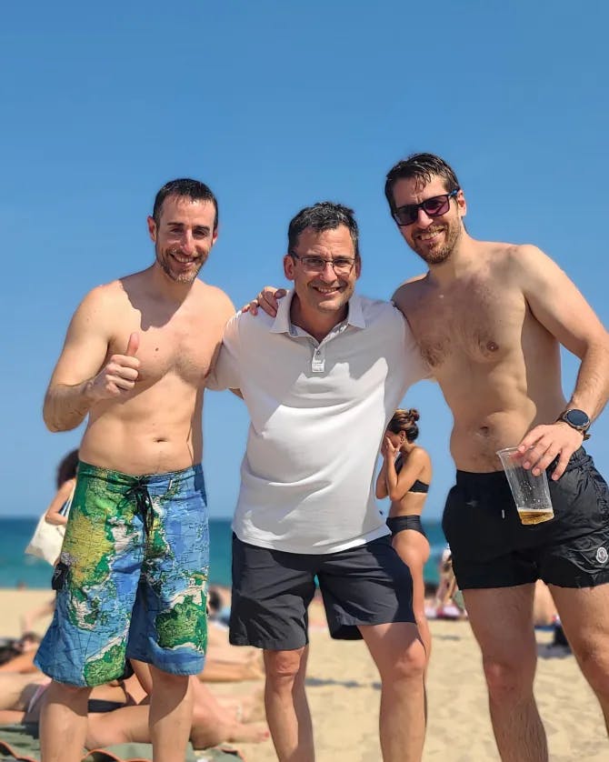 Men posing on beach 