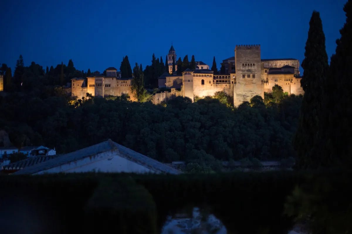 A well lit palace at night.