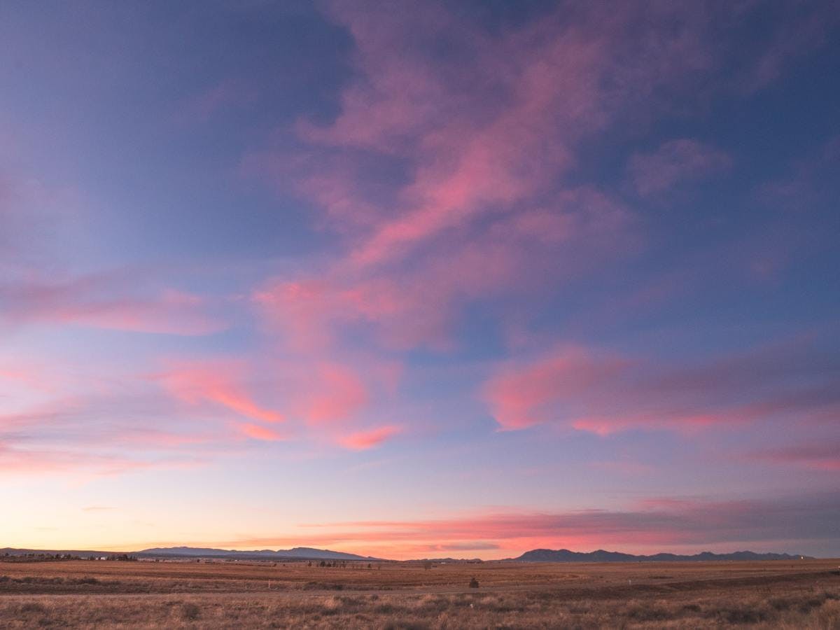 Sunset with pink clouds on desert valley in New Mexico. 
