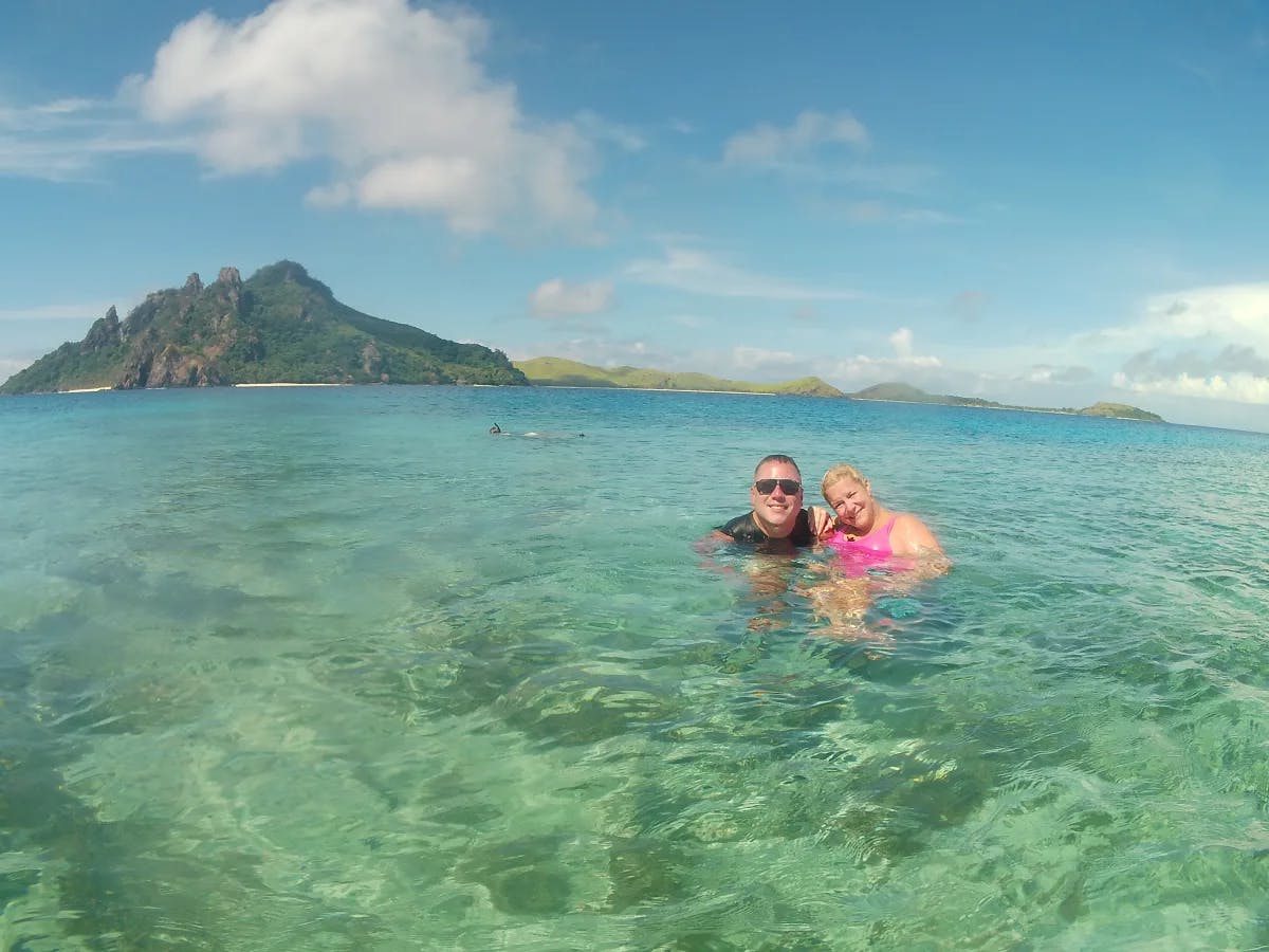 A picture of a couple in the water in crystal clear waters off Modriki Island.