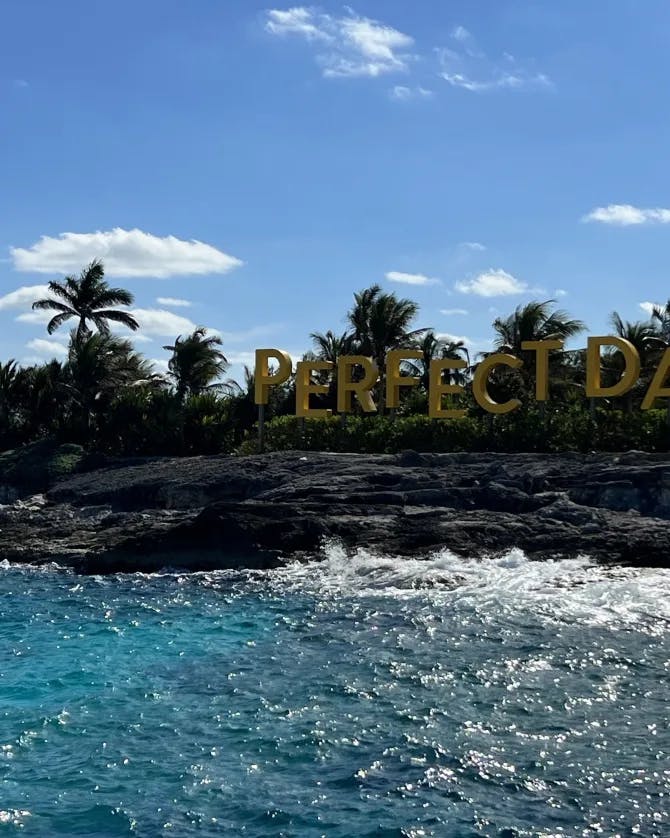 Perfect day sign on a rocky sea shore