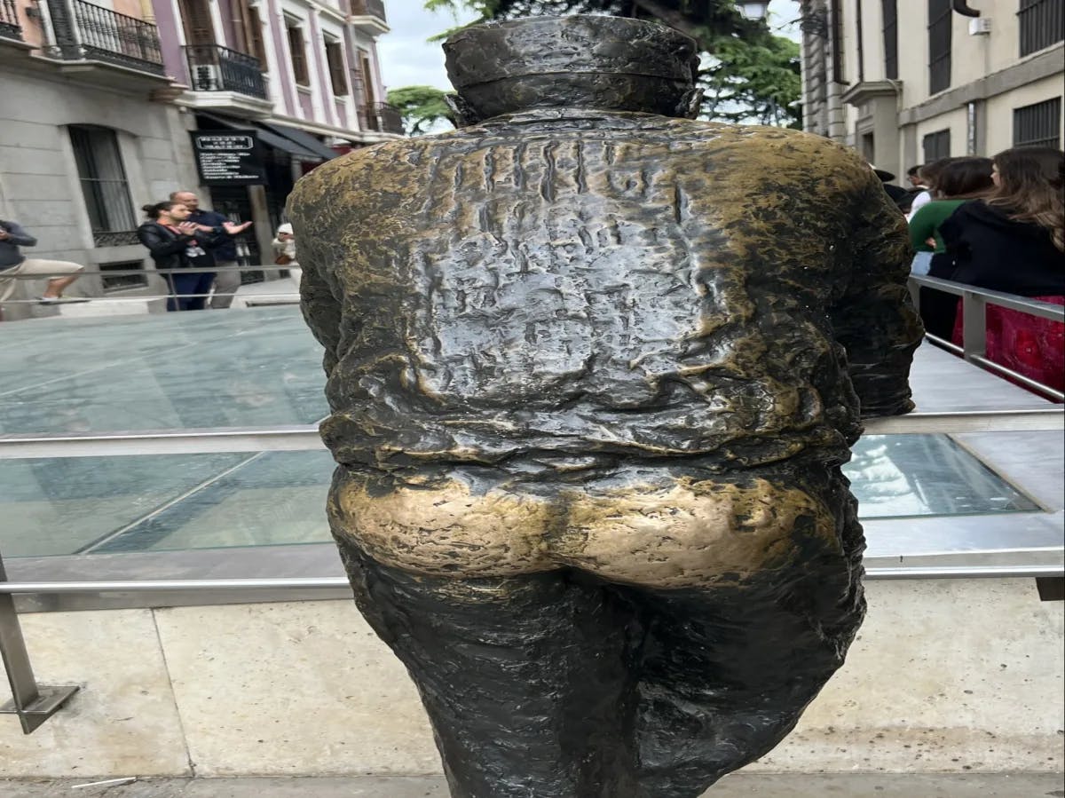 A well-worn bronze statue, polished by frequent touches