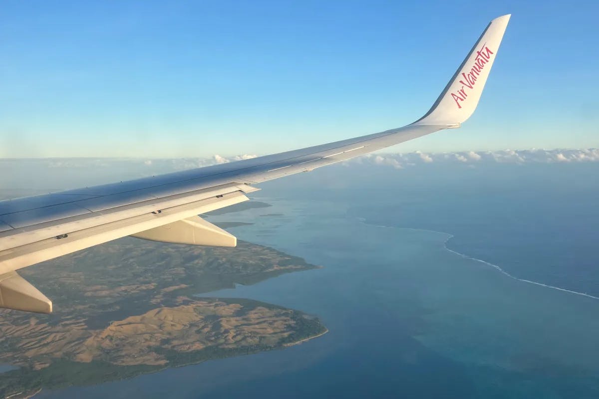 A view over Vanuatu island on a sunny day from an Air Vanuatu window. 