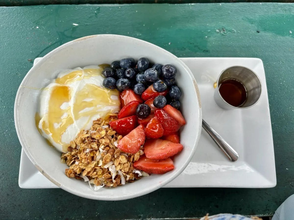 Breakfast cereal with yogurt, blueberries and strawberries.