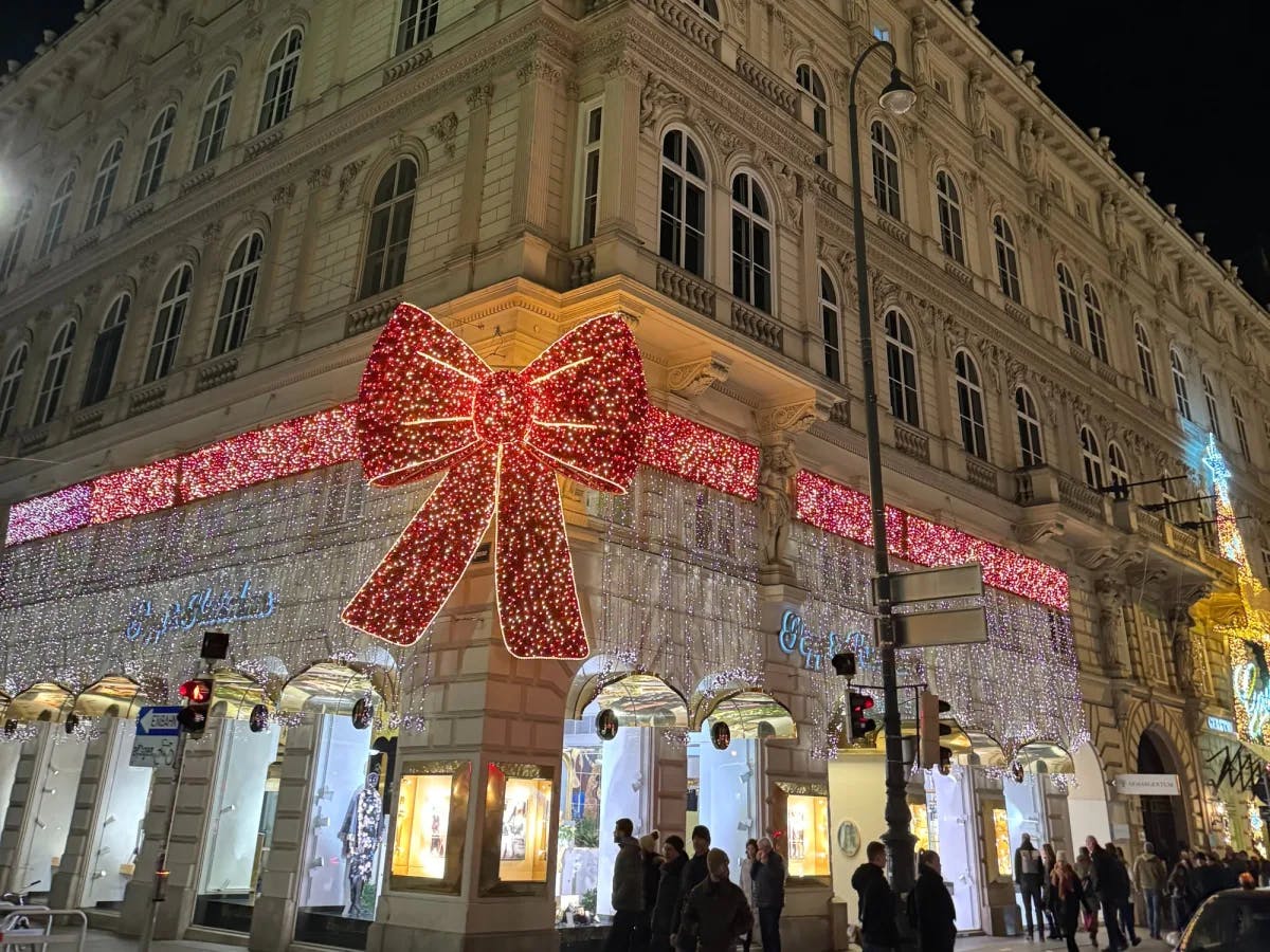 A building with decorative light bow at night. 