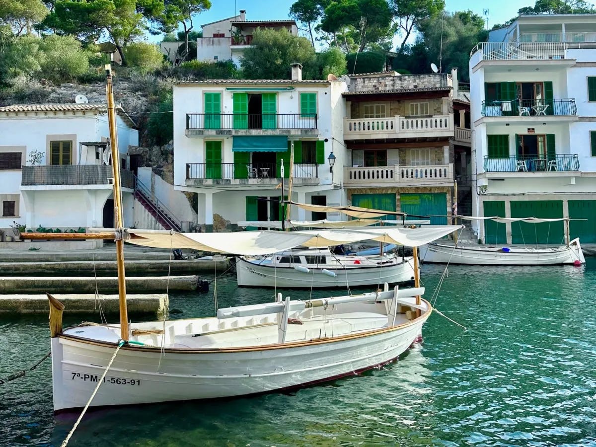 A water body with boats in front of buildings.