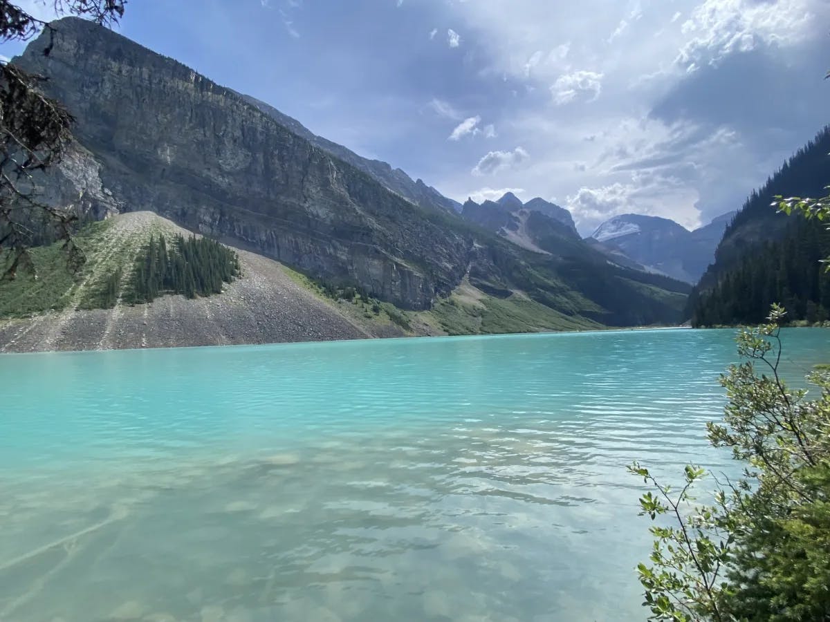 A turquoise lake surrounded by mountains. 