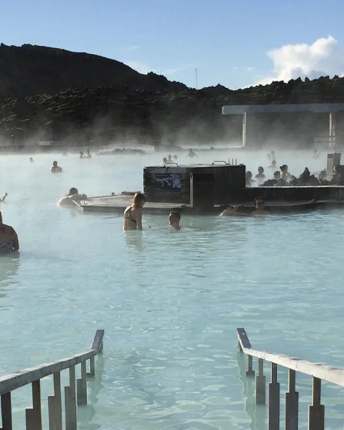 People in a large blue hot spring