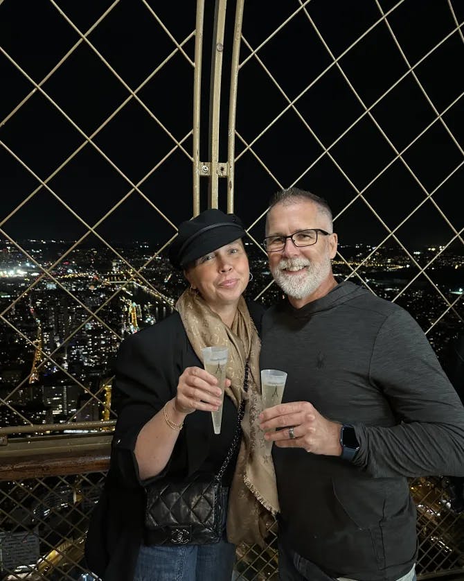 Picture in black dress with drink in hand at night