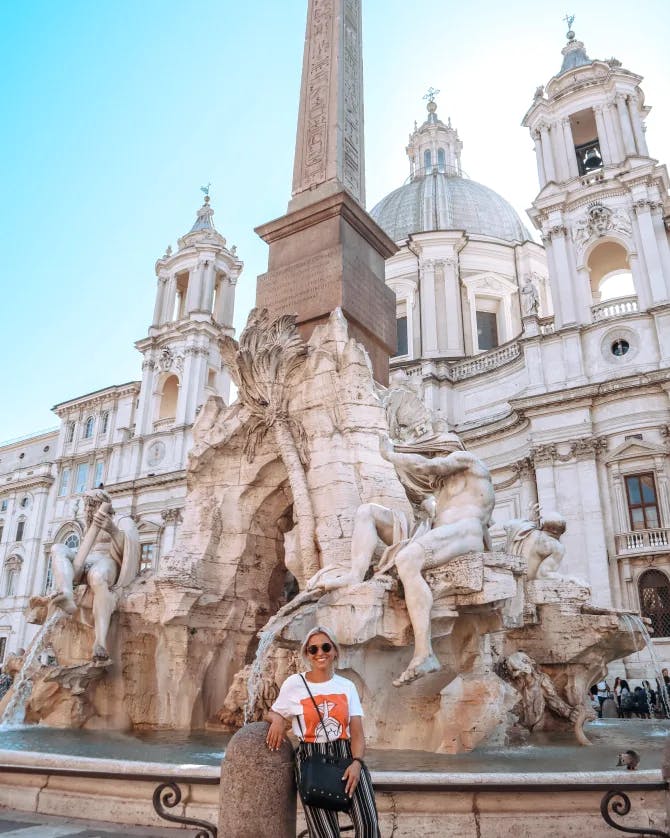 Travel advisor posing in front of an ancient building