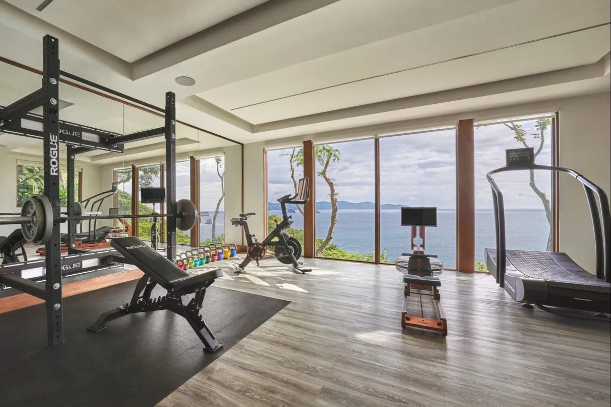 One of many fitness centers at Four Seasons Resort Costa Rica with updated equipment and ocean views through floor-to-ceiling windows